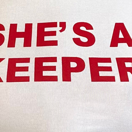 Salda Tee in White with She's a Keeper and Tango Red Binding