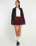 image of Zabini Low Rise Pleated Mini Skirt in Burgundy with Ecru Stitch Detail